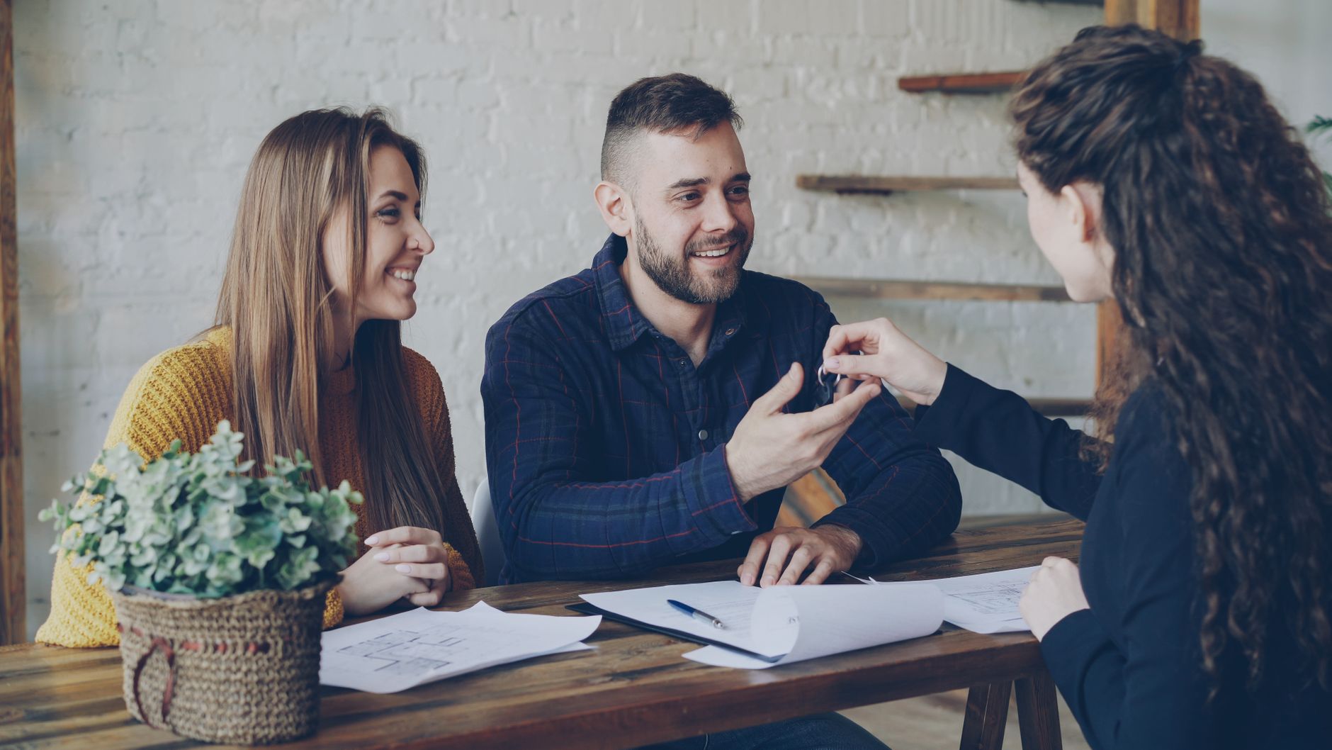 Smiling couple looking through house deeds